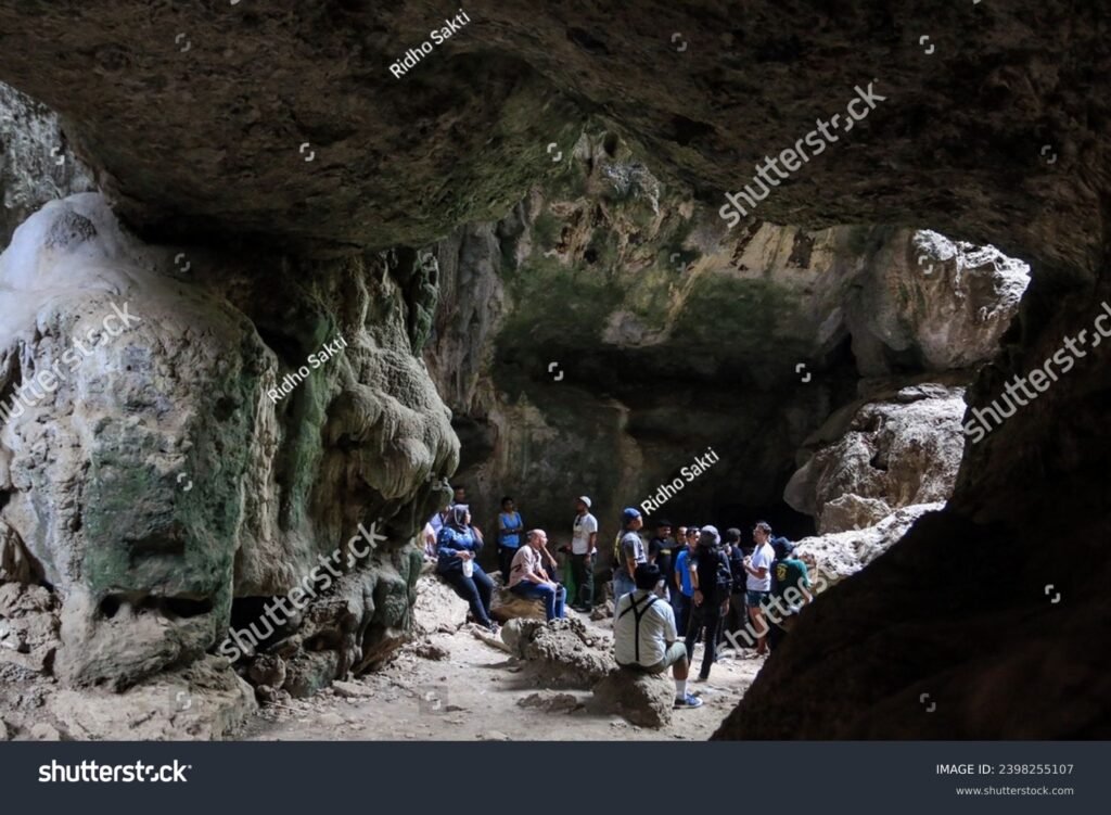 stock-photo-east-nusa-tenggara-indonesia-december-tourists-enjoy-the-atmosphere-of-batu-cermin-cave-2398255107